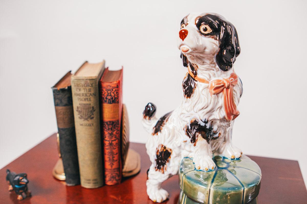 Staffordshire Spaniel Dog Porcelain Figurine Resting on a Green Tufted Footstool