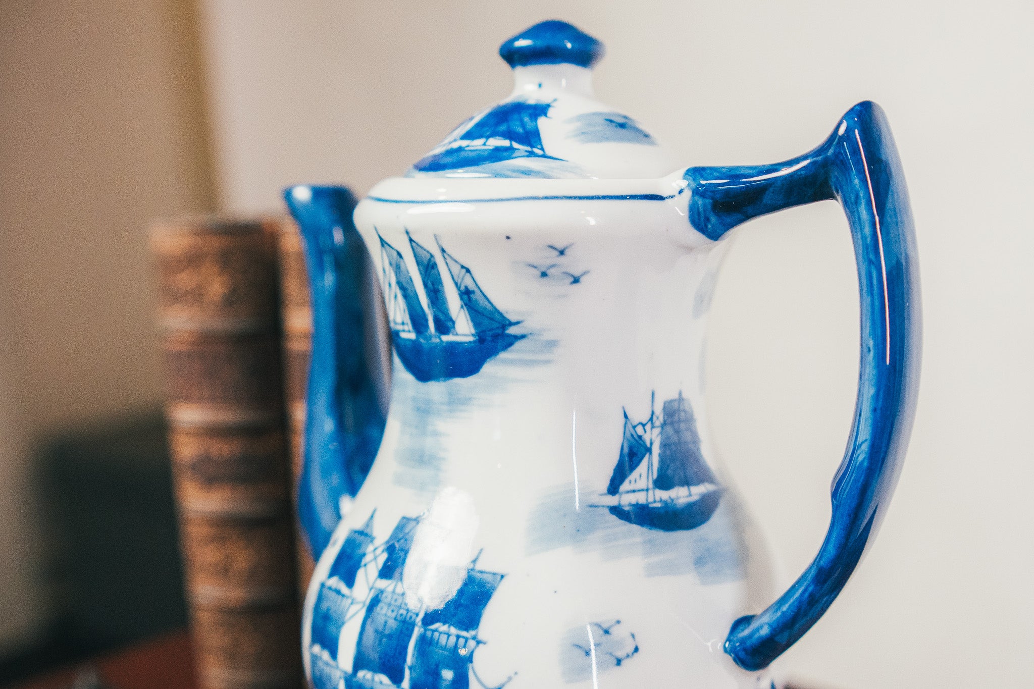 Ceramic teapot with blue and white design on a plain background